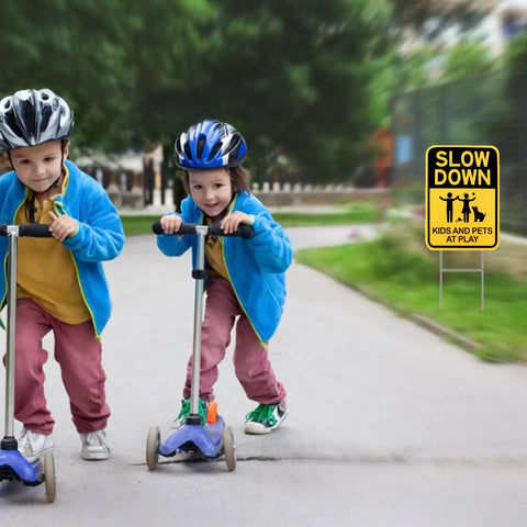 Slow Down Signs With H Stake 16x12 Inches Kids And Pets At Play Double Sided Street Safety Signs installed in a park