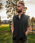 Men's Heavy Duty Softshell Vest With Smooth Four Way Stretch And Plush Fleece Lining designed for outdoor comfort in a scenic setting.