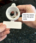 Clear Reusable Plant Labels For Hydroponics Indoor Herb Gardens And Outdoor Systems 8 Pack Durable Plastic Tags being slotted into a grow cube