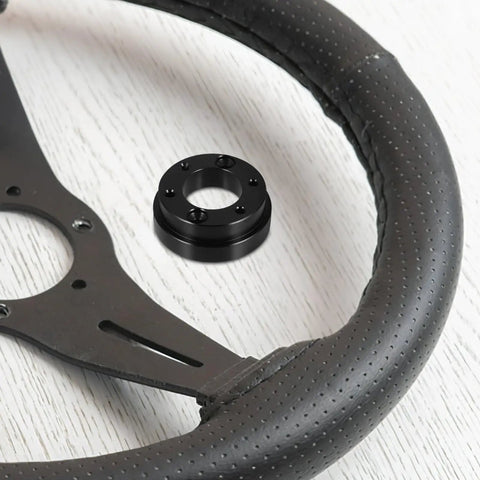 Racing Car Wheel Adapter Plate Riser Tool For Enhanced Control In Various Racing Cars next to steering wheel
