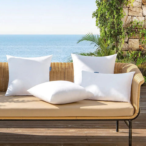Set Of 4 18x18 Outdoor Pillow Inserts, Water Resistant Cushion Shams on patio sofa with sea view, garden decor.