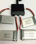 Four Pack 3.7V 650mAh LiPo Batteries With a 4 in 1 Battery Charger for Syma X5 X5C X5C1 RC Drones displayed with charger