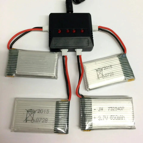 Four Pack 3.7V 650mAh LiPo Batteries With a 4 in 1 Battery Charger for Syma X5 X5C X5C1 RC Drones displayed with charger