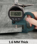 Thickness measurement of grey peel and stick floor tiles, showing 1.6mm, part of 12x12 inch wood vinyl flooring, 20 pack.
