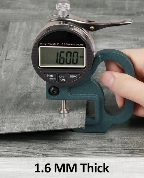 Thickness measurement of grey peel and stick floor tiles, showing 1.6mm, part of 12x12 inch wood vinyl flooring, 20 pack.