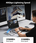Kickass 40Gbps M.2 NVMe SSD Enclosure Featuring Active Cooling Fan No Hassle Aluminum Crystal Body For 2280 Drives in use with laptop and monitor.