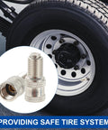 Brass nickel-plated double-seal tire valve stem cap; close-up view with wheel in background; pack of 50.