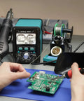 Hand using 2 in 1 Soldering And Hot Air Station Kit with 110W soldering iron, LCD display, and tools for electronics repair.