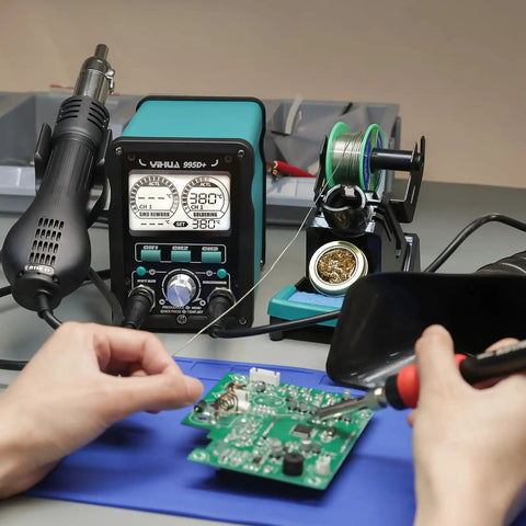 Hand using 2 in 1 Soldering And Hot Air Station Kit with 110W soldering iron, LCD display, and tools for electronics repair.