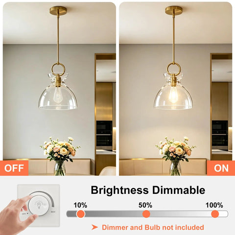 Super Sleek Brushed Gold Pendant Light For Kitchen Island Featuring Fully Adjustable Hanging Cord And Large Clear Glass Shade creating a modern vibe with dimmable brightness.