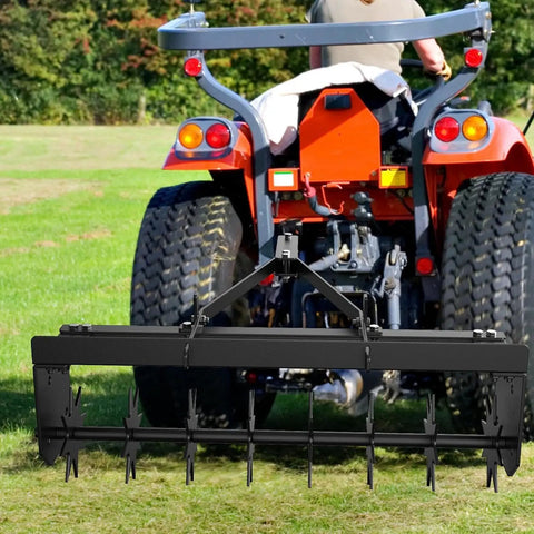 32 Inch Tow Behind Spike Aerator with durable steel tines, hitched to a red tractor on a green lawn, showing deep soil penetration