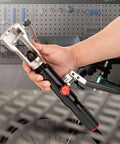 Hand holding All-in-One Hydraulic Brake Line Flaring Tool Kit for 3/16 to 1/2 Inch Copper and Steel Tubing in workshop