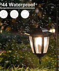 Solar Hanging Lights For Outdoors, 2 Pack With 38 Inch Shepherd Hooks, Waterproof Garden Lanterns glowing in rainy garden