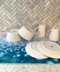 Premium Heavy Duty Polyester Kitchen Sink Dish Drying Mat With Ultra Absorbent Quick Dry Pads For Countertops And Delicate Glassware on marble countertop with dishes.