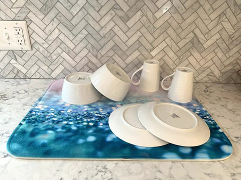 Premium Heavy Duty Polyester Kitchen Sink Dish Drying Mat With Ultra Absorbent Quick Dry Pads For Countertops And Delicate Glassware on marble countertop with dishes.