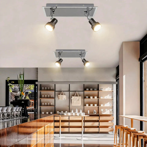 Six Head LED Track Light Kit With Rotatable Heads And Foldable Arms For Kitchen Living Room Dining Room And Office Directional Ceiling Spotlight Flush Mount Energy Saving And Easy Install installed in a modern room with shelves and seating.