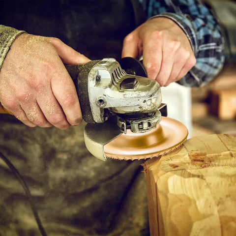 Person using angle grinder with Five Piece Wood Carving Disc Set For Four Inch And Four And A Half Inch Angle Grinders With Seven Eighth Inch Arbor