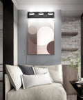 LED Modern Black Vanity Light With Acrylic Finish Over Mirror Three Light Bathroom Wall Fixture With 360 Degree Rotatable Joint And Up And Down Lighting mounted on wall above artwork in living space.