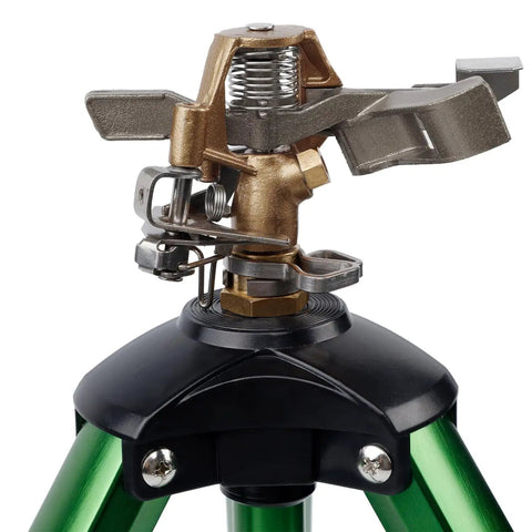Close-up of Beefy Impact Sprinkler Head On Tripod Base For Lawn Irrigation, metal nozzle detail and solid alloy legs.