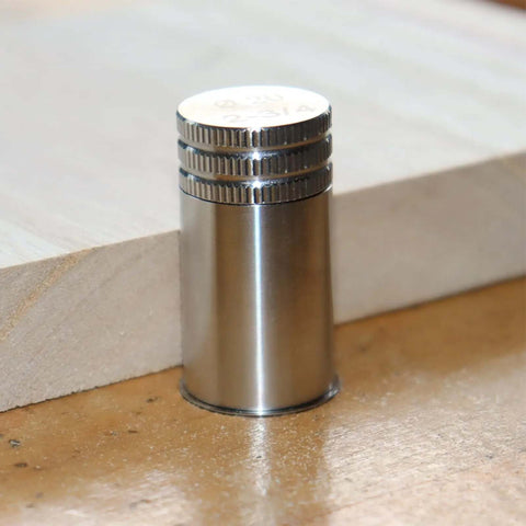Close-up of 20mm stainless steel bench dog from set with rubber connector, for T-track workbenches and tables, rock solid hold