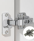 Close-up of a mounted 90-degree soft-close cabinet hinge with inset image of gray clip from 50 Pack Cabinet Hinge Restrictor Clips.