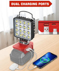 Cordless LED Work Light With 6000 Lumen Output And 38W Power, USB ports charging phone, red and gray design on table
