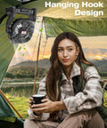 Portable Camping Fan With Led Lights And 20000mAh Battery hanging in tent with woman holding cup, outdoor setting, sunset view