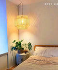 Handcrafted Rattan Plug In Pendant Light Featuring Smooth Dimmable Switch And Handwoven Wicker Bamboo Shade in cozy bedroom setting.