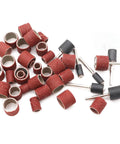 Sunxeke sanding drum set components: red aluminum oxide sleeves and mandrels scattered on white background, front view
