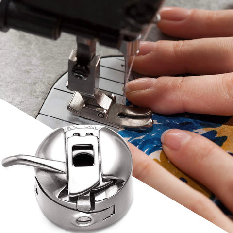 Stainless steel bobbin case for front-loading 15-class sewing machines; two-view: presser foot top, bobbin housing bottom.