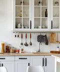 Modern kitchen with 12 Pack Matte Black Cabinet Handles 5 Inch 128 mm Aluminum Drawer Cupboard Pulls installed on white cabinets.