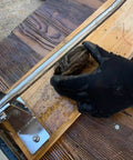 Premium Stainless Steel Oyster Opener with Knife on Wooden Base in use, showing black-gloved hand shucking an oyster.