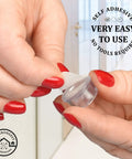 Close-up of a person holding a clear self-adhesive rubber bumper from 16 Pack Tiny Door Stoppers Wall Protectors.