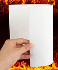 White ceramic fiber gasket paper sheet, 7 x 10 in, 1/8 in thick, held by hand with fire background