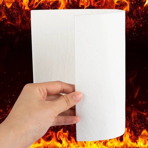 White ceramic fiber gasket paper sheet, 7 x 10 in, 1/8 in thick, held by hand with fire background