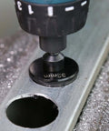 Close-up of a black 33mm hole saw arbor mounted in a drill chuck.