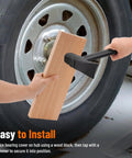 Trailer wheel bearing protector kit, 1.98-inch, being installed on a trailer hub with a wooden block and hammer.