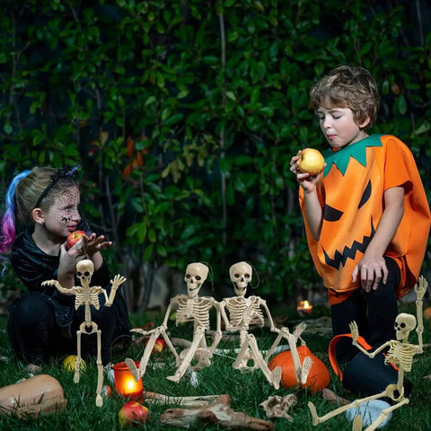 Children dressed for Halloween with Six 16 Inch Full Body Poseable Skeletons With Movable Joints For Halloween Indoor Outdoor Spooky Decor