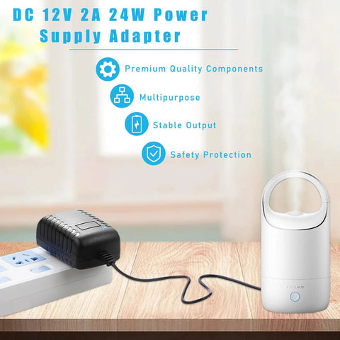Solid Build AC To DC Converter 100-240V To 12V 2A 24W with black plug connected to a mini gadget on a wooden table.