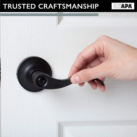 Hand using Privacy Door Lever Set for Bedroom and Bathroom, Matte Black Wave Style, reversible interior lever, easy coin unlock.