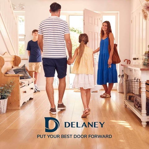 Family entering a bright home through an open door, logo for Delaney visible at the bottom, sunny interior.