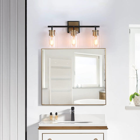 Black And Gold Modern Farmhouse Vanity Light With Copper Accent Socket And Back Plate Three Clear Glass Shades 19.7 Inch Bar Easy Install Bathroom Lighting That Elevates Your Space To A Killer Vibe in a bathroom setting
