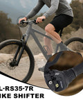 Cyclist riding bike with focus on 7 Speed Right Twist Shifter Lever For Mountain Bike, Commuter Bike, And Folding Bike, Easy Fingertip Shifting