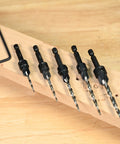Killer 5 Piece Countersink Set For Screw Sizes 4 Through 12 Adjustable Four Cutter Drill Bit arranged on wood with hex key spacer