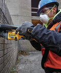 Worker using 60V Max Brushless Cordless Grinder With Kickback Brake Four And A Half Inch To Six Inch Wheel 9,000 RPM No Load Speed High Power Tool Only Renewed For Metal Fabrication And DIY Projects on brick wall.