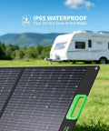 100W Portable Foldable Solar Panel For Power Stations And Generators Ideal For Outdoor Camping Van Life And RV Trips High Efficiency Solar Charger With 20V Output And Support For Multiple DC Adapters in a field next to an RV, showing waterproof feature with water droplets.