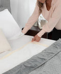 Hella Soft Disposable Underpads For Adults And Elders Xxl Leakproof Incontinence Bed Pads 30By30 Beige being placed on a bed.