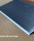Heavy Duty Bench Scraper For Flat Top Griddle with precision beveled edge, stainless steel surface on wooden background