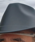 Close-up of Vulcan Cowboy Style Hard Hat With Six Point Deluxe Nylon Ratchet Suspension And Front Cotton Sweatband, worn outdoors.