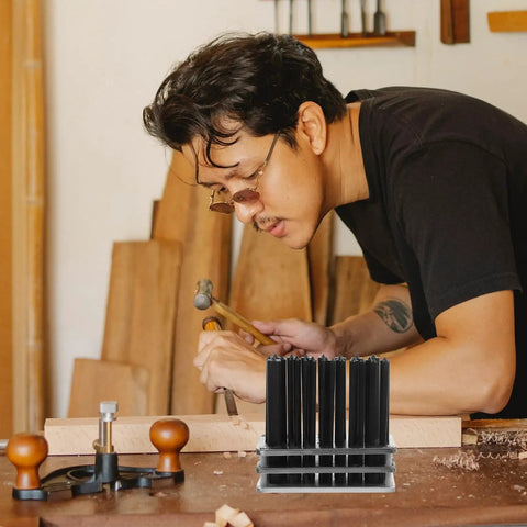 Man using 28 Piece Steel Punch Set with Single Hole Puncher for Mechanical Repair and DIY Projects in workshop